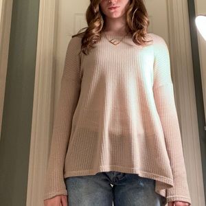 Tan knit sweater that is open in the back